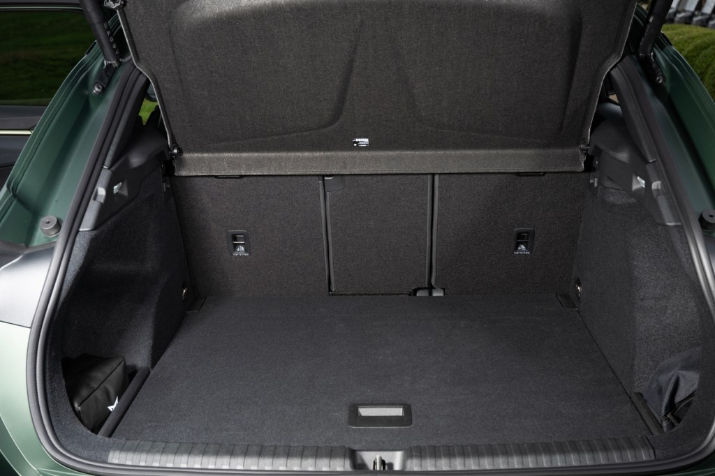 Interior view of a car trunk with a flat cargo area and a textured black lining.